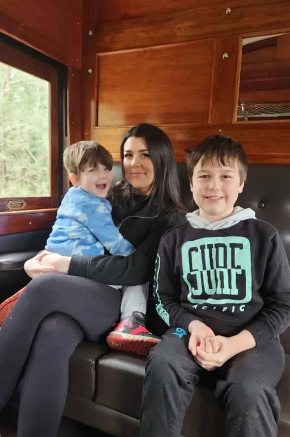 mother and two sons on a train