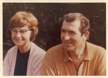 A man and a woman sitting smiling