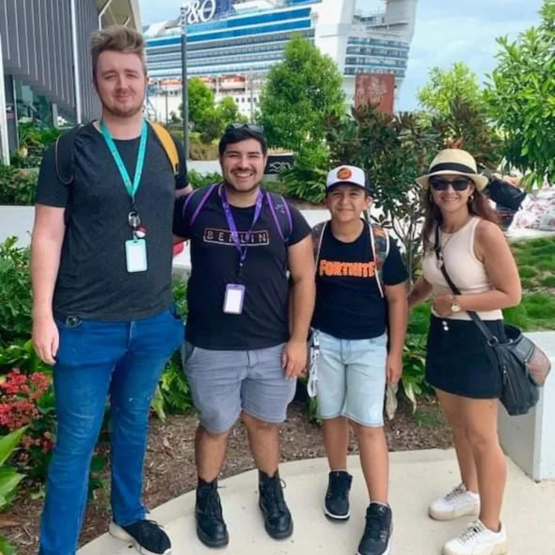 four people standing outside smiling for camera