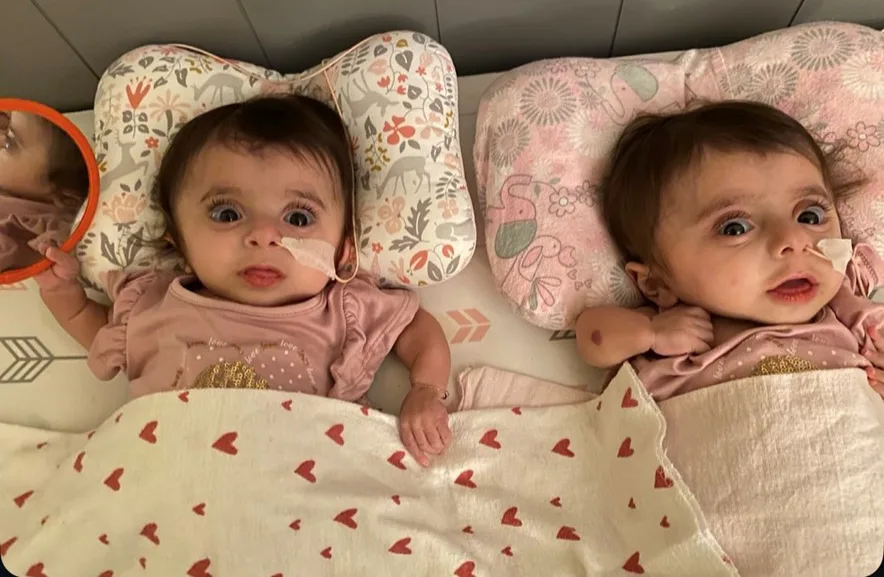 Twin baby girls in bed