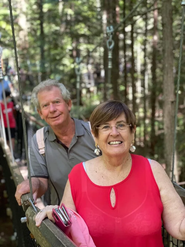 A man and woman smiling outdoors