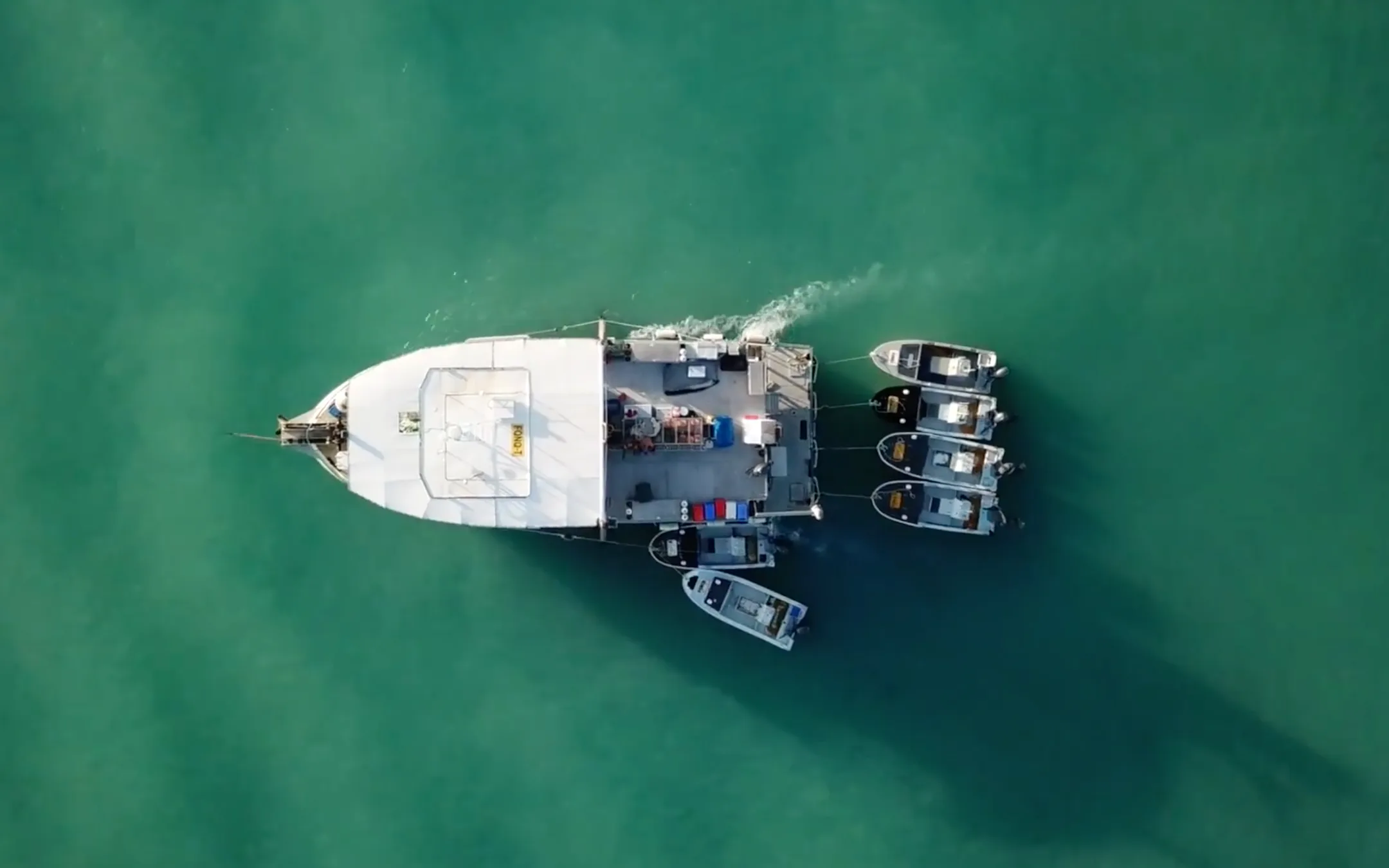 Image of a main ship towing little boats