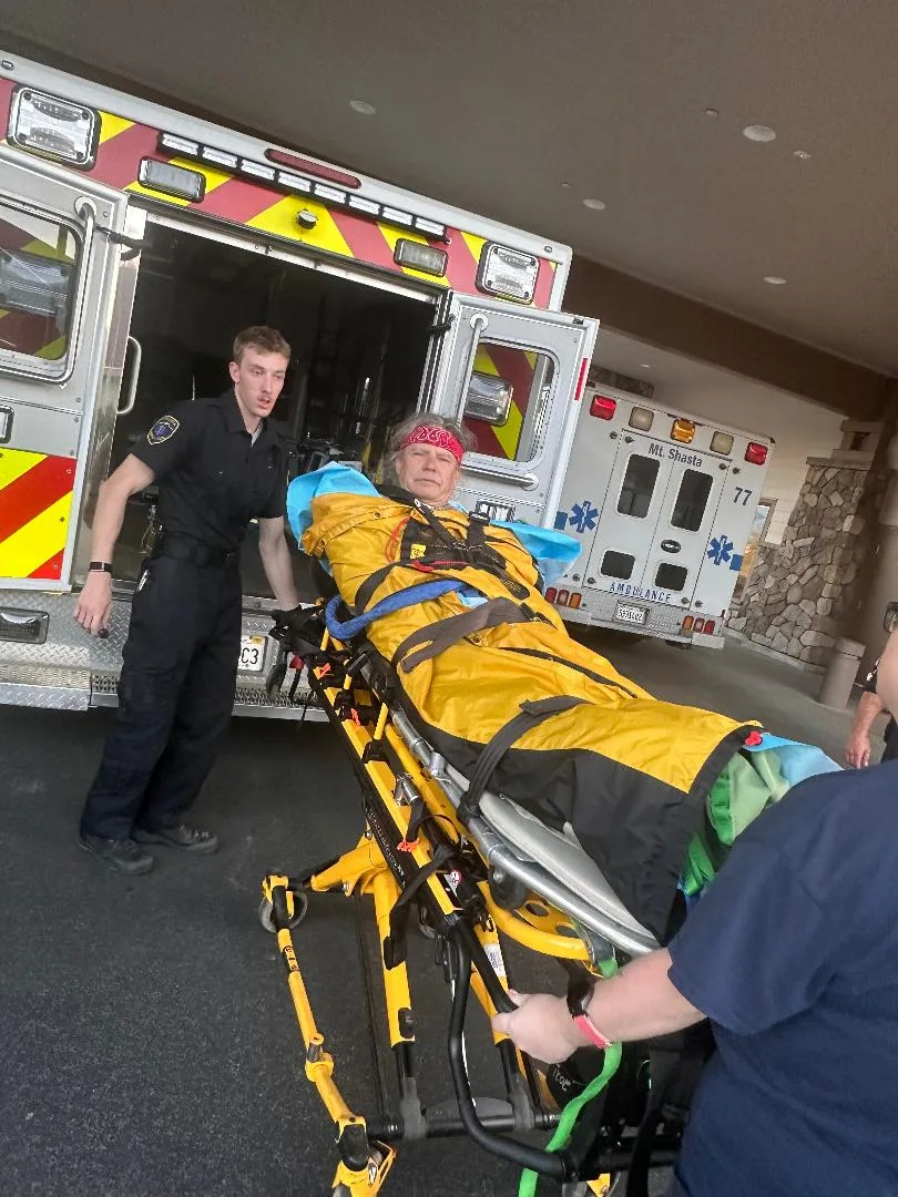 man in red headband on hospital gurney