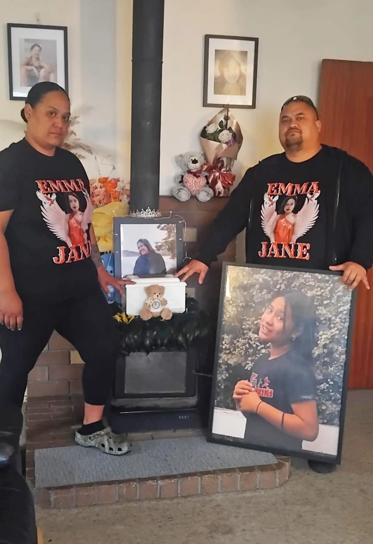 parents standing in front of memorial photos of their daughter