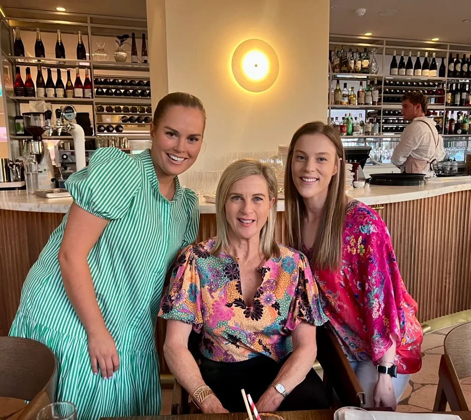 three women in café wearing bold outfits
