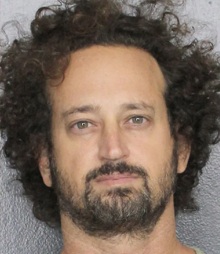 man with curly hair mugshot