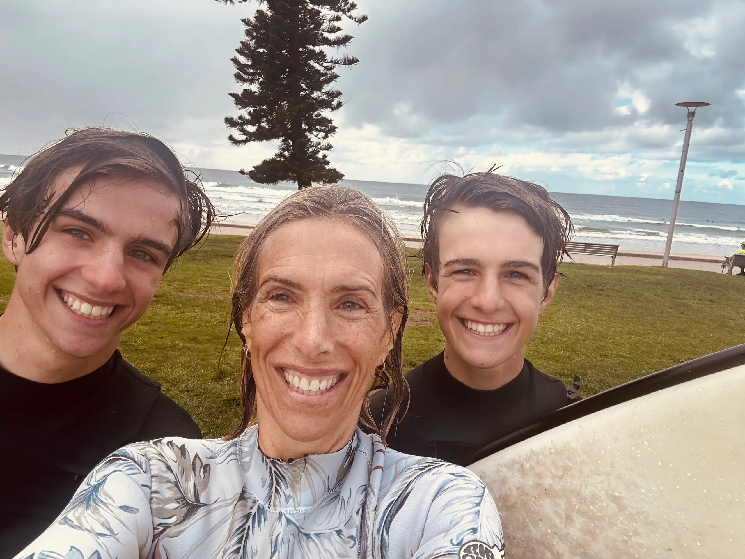 mother and two sons leaving the beach 