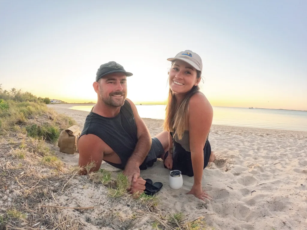 A man and woman siting on the beach