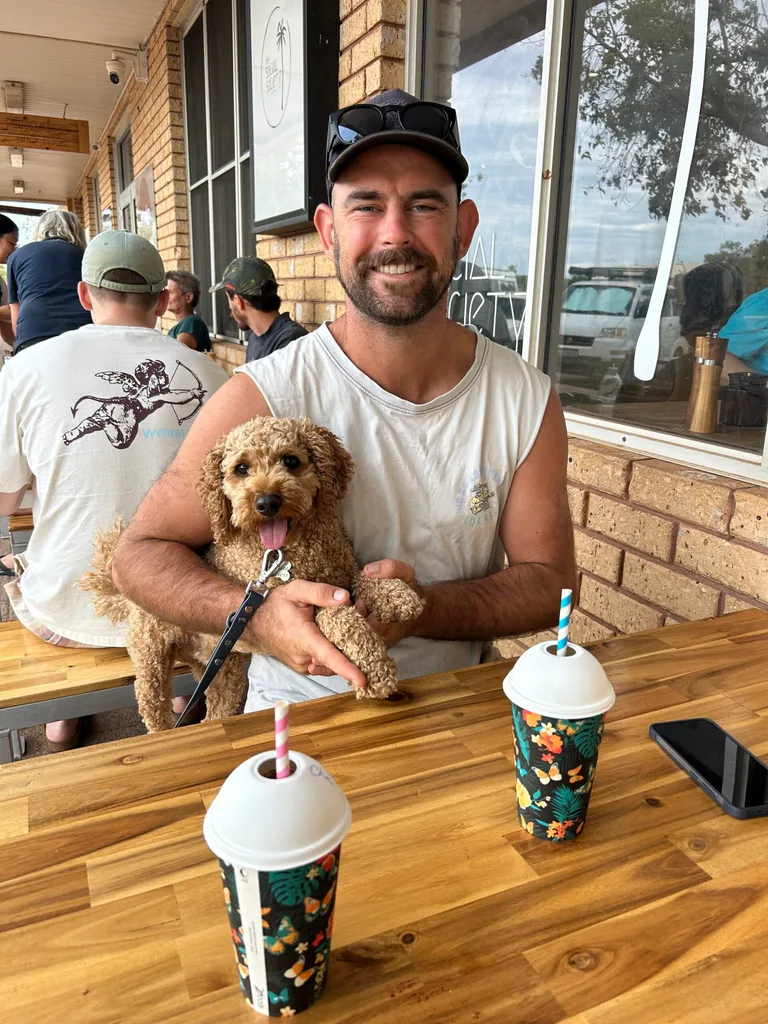 Man with a dog at an outdoor cafe