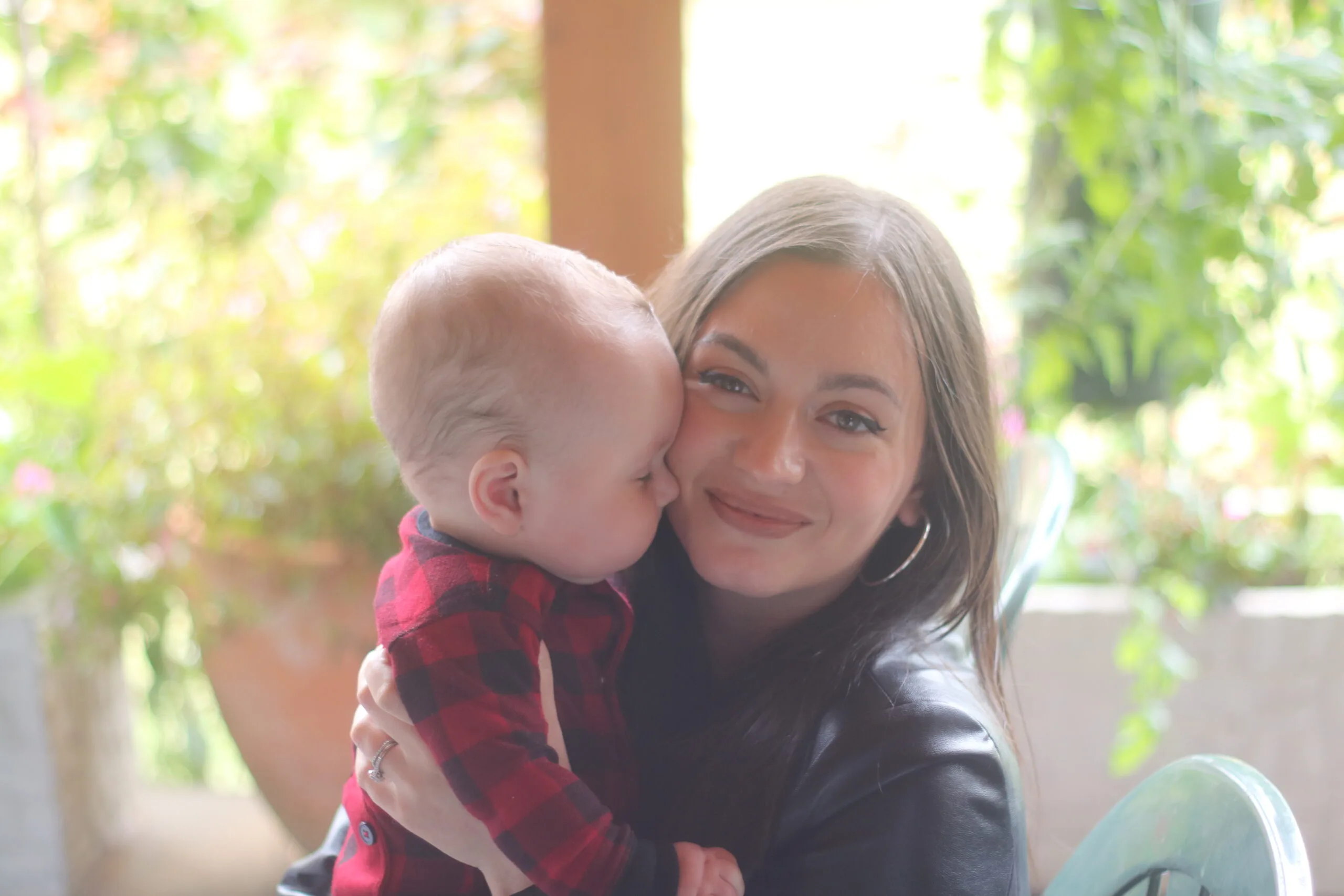 woman with dark hair holding her baby 