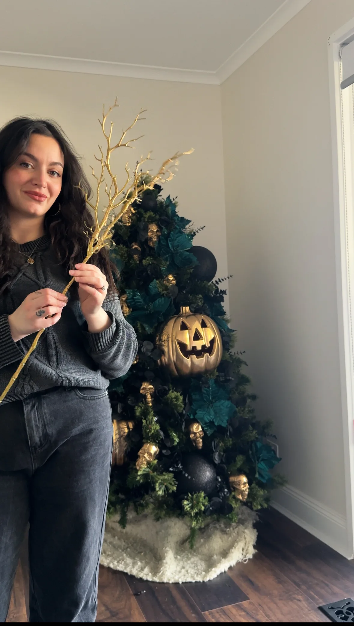 woman decorating halloween tree