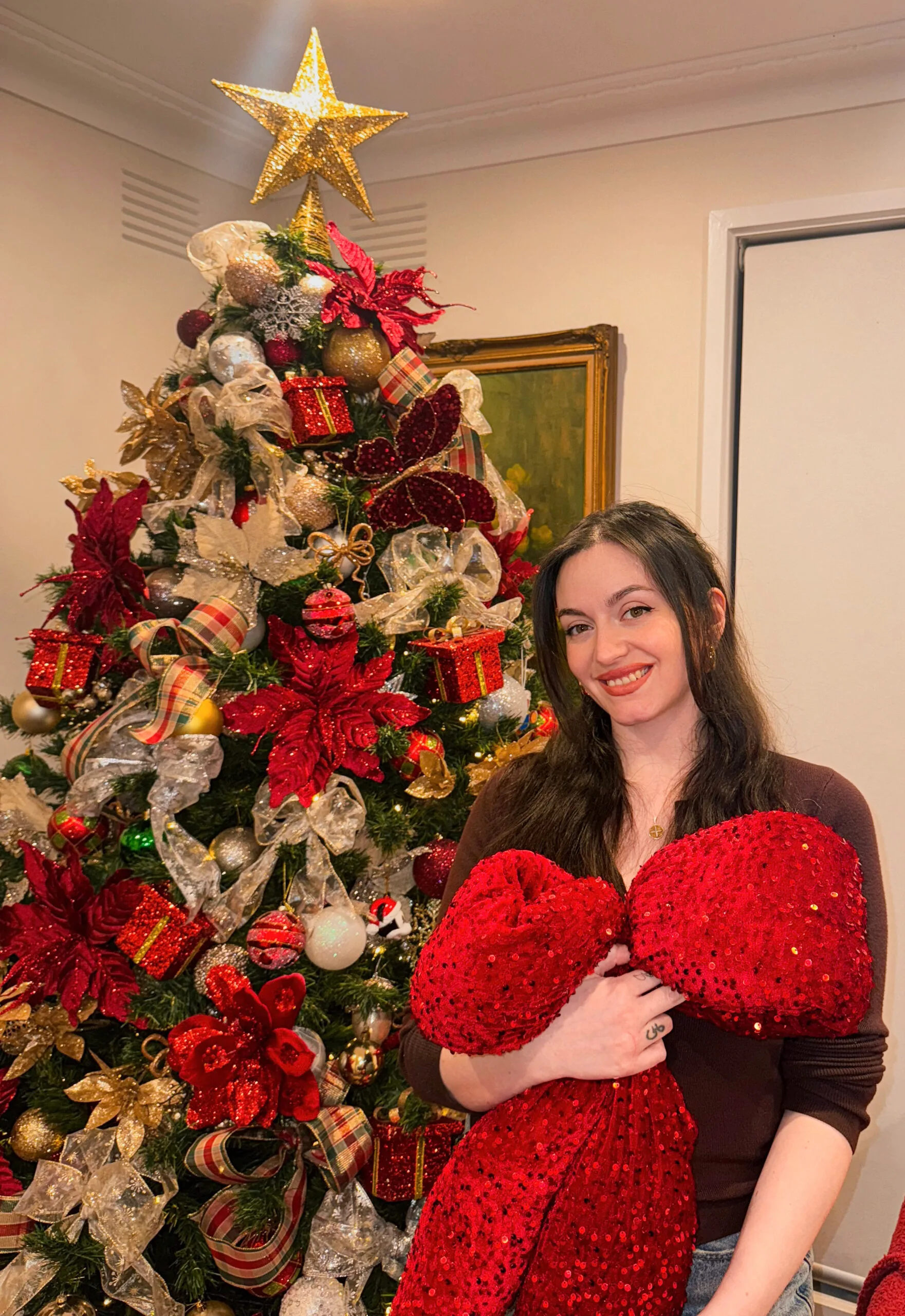 woman dark hair holding red bow