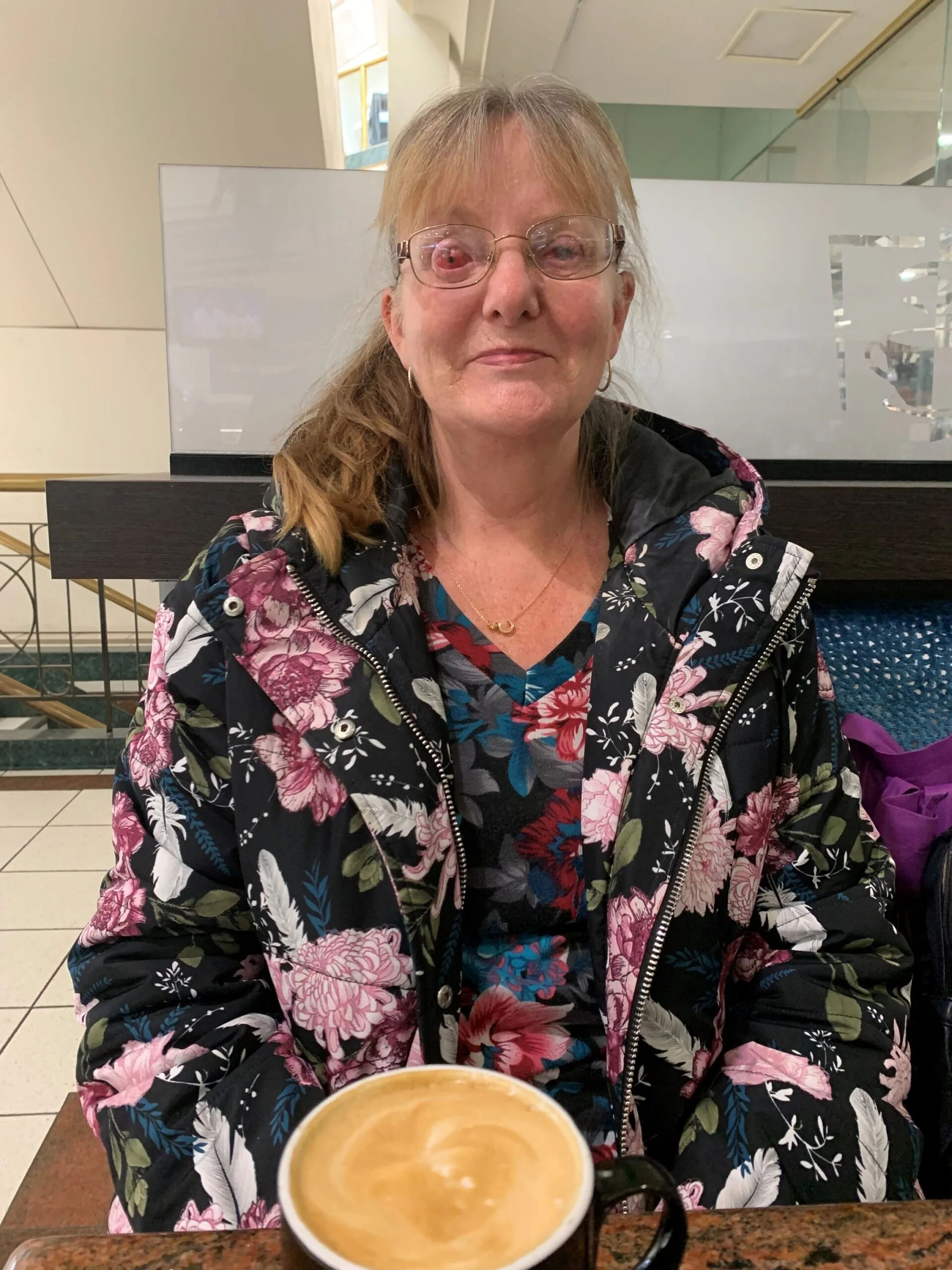 woman sitting down drinking coffee