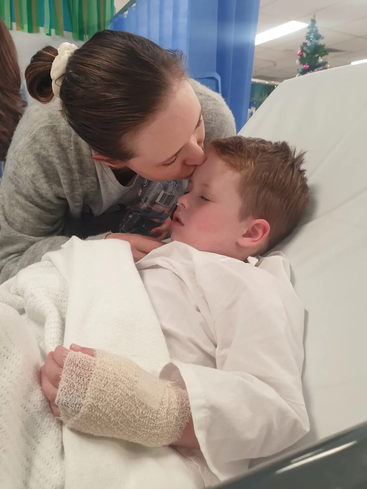 woman and her young child who is in hospital bed