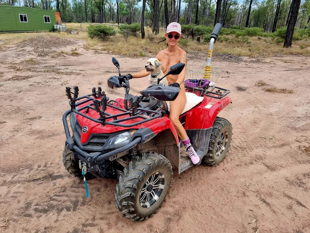 Image of woman sitting on a quad bike in the nude