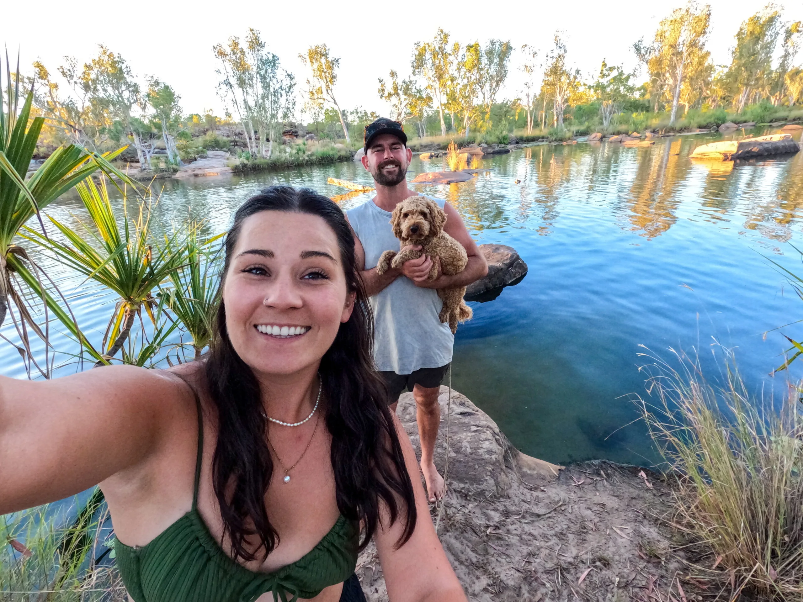 Woman, man and dog at a waterhole