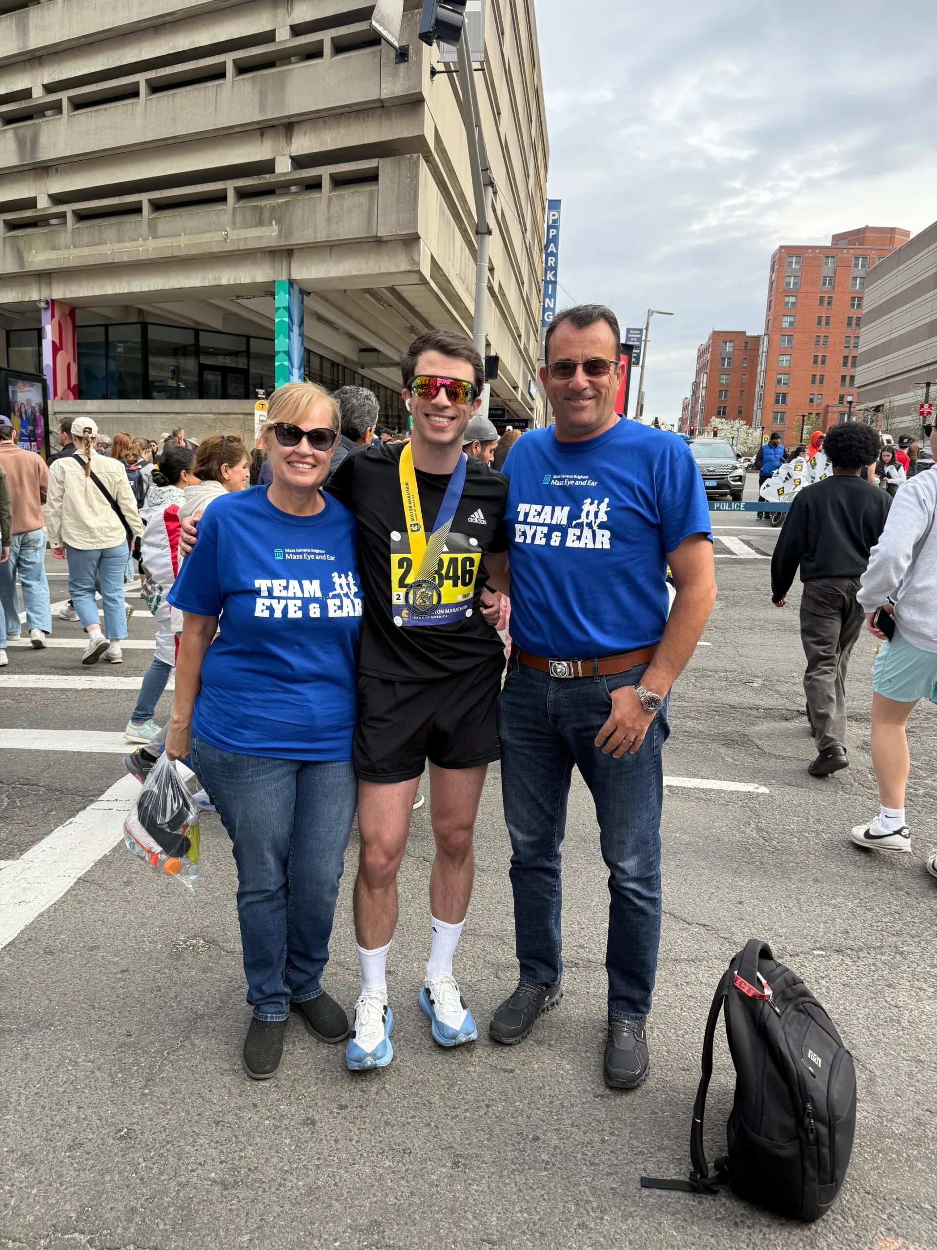 Image of parents and their son after running a marathon