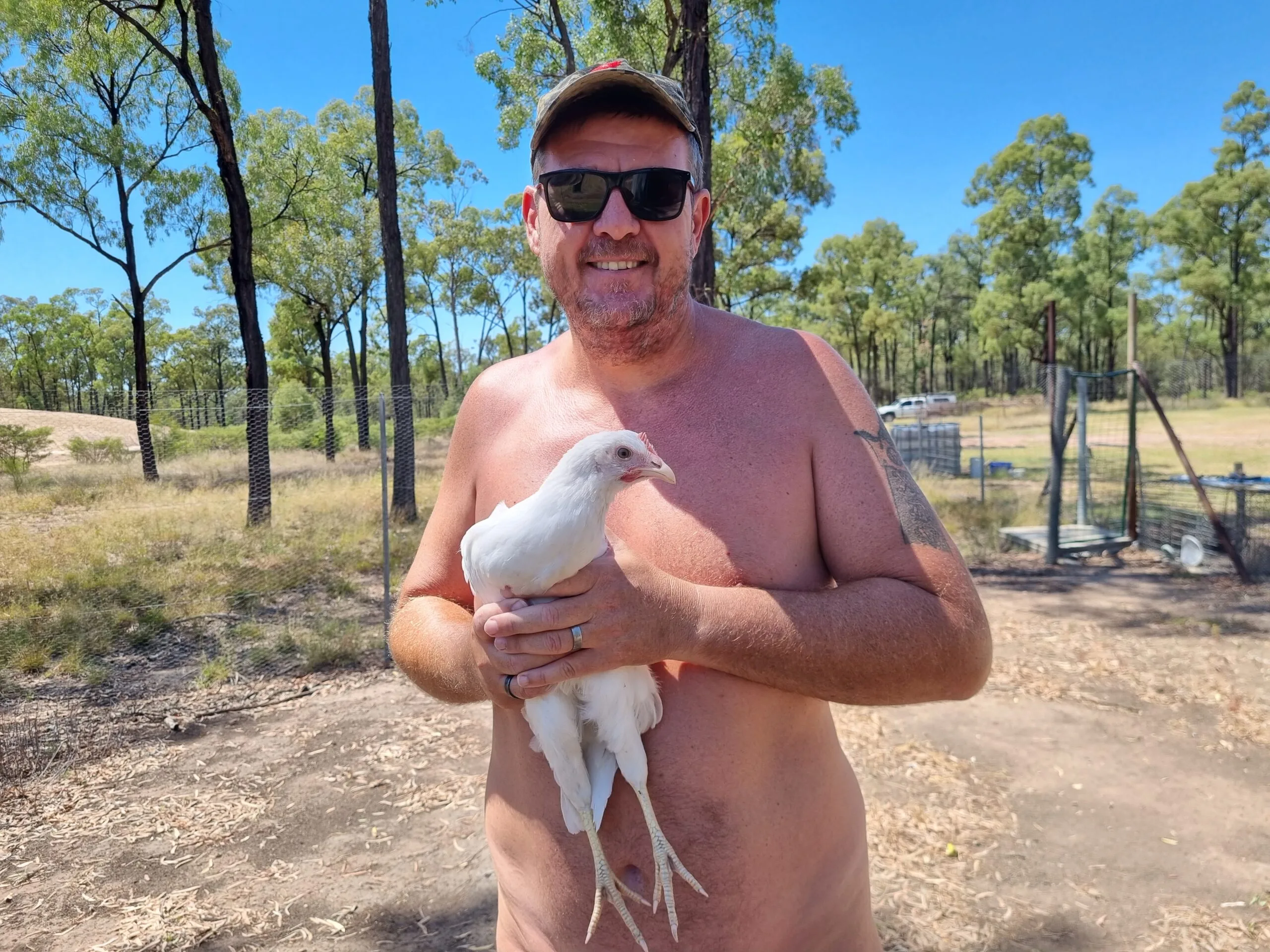 Image of man holding chicken