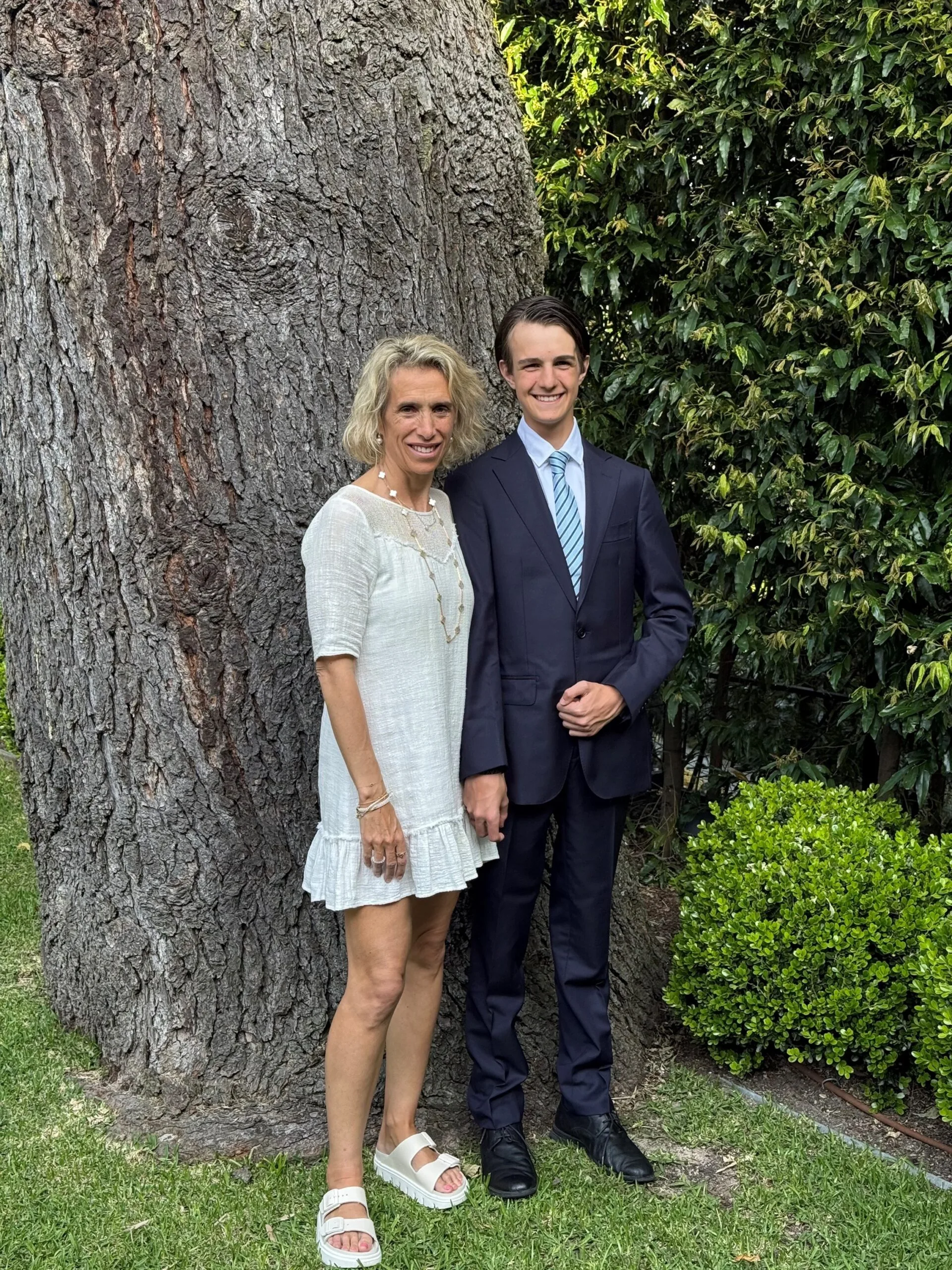 mother and son by a tree
