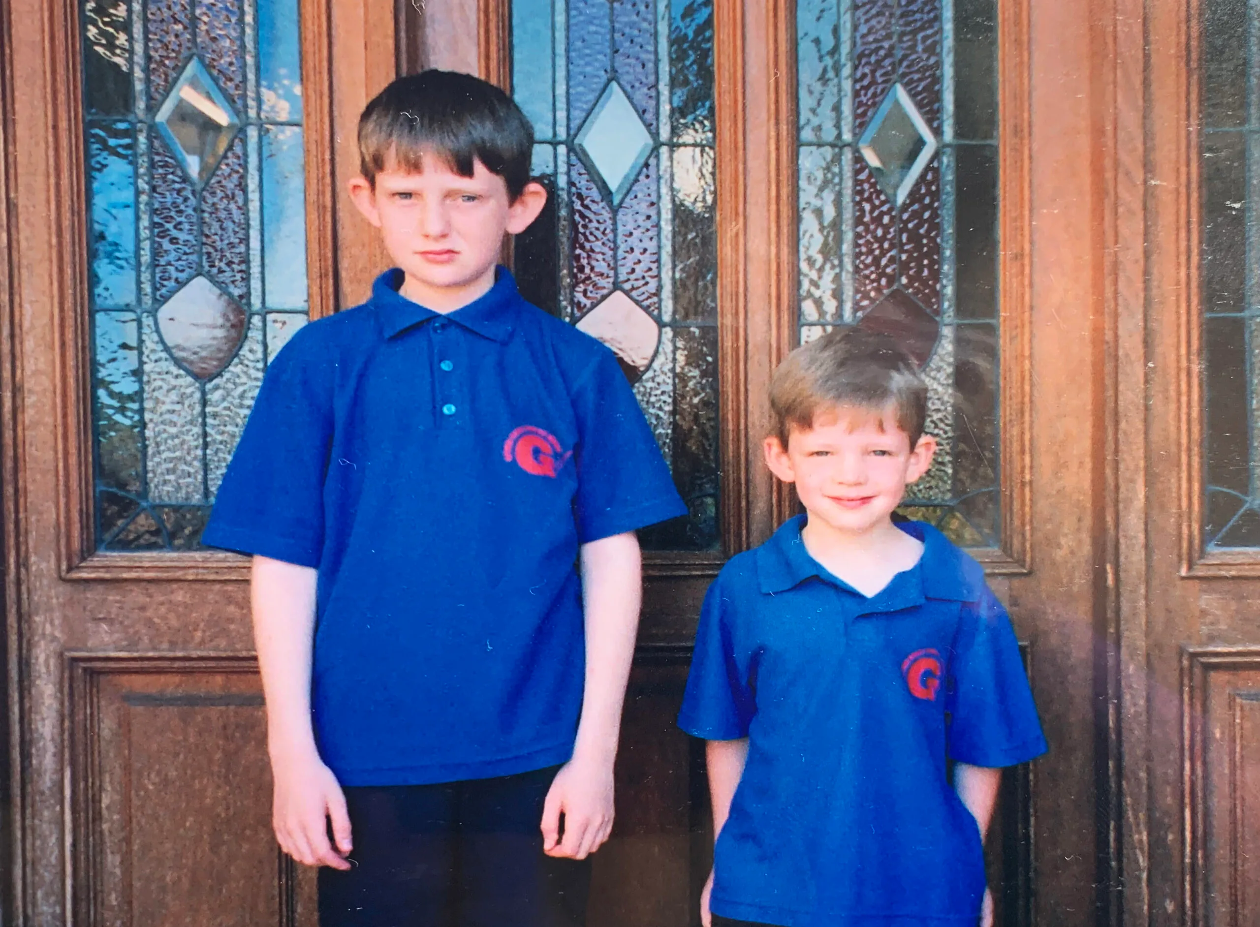 two school kids in dark blue school shirts