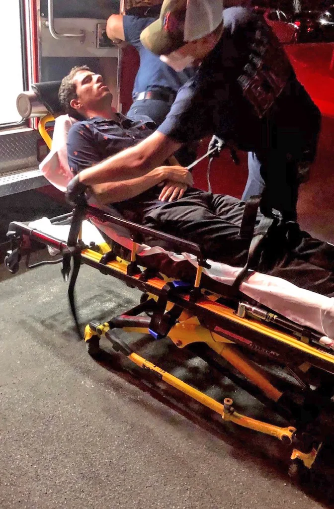 Image of man being cared for by paramedics