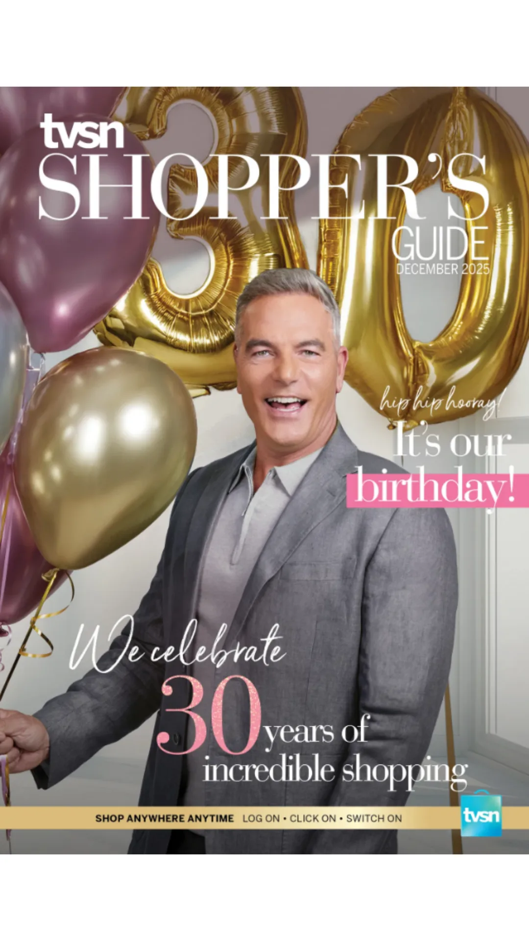 A man in a grey suit happily holds balloons to celebrate TVSN's 30th anniversary.