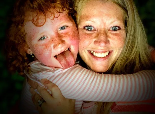 Left: Little girl with red hair and freckles poking tongue out at camera.
Right: Woman with blonde hair and blue eyes hugging little girl and smiling at camera.