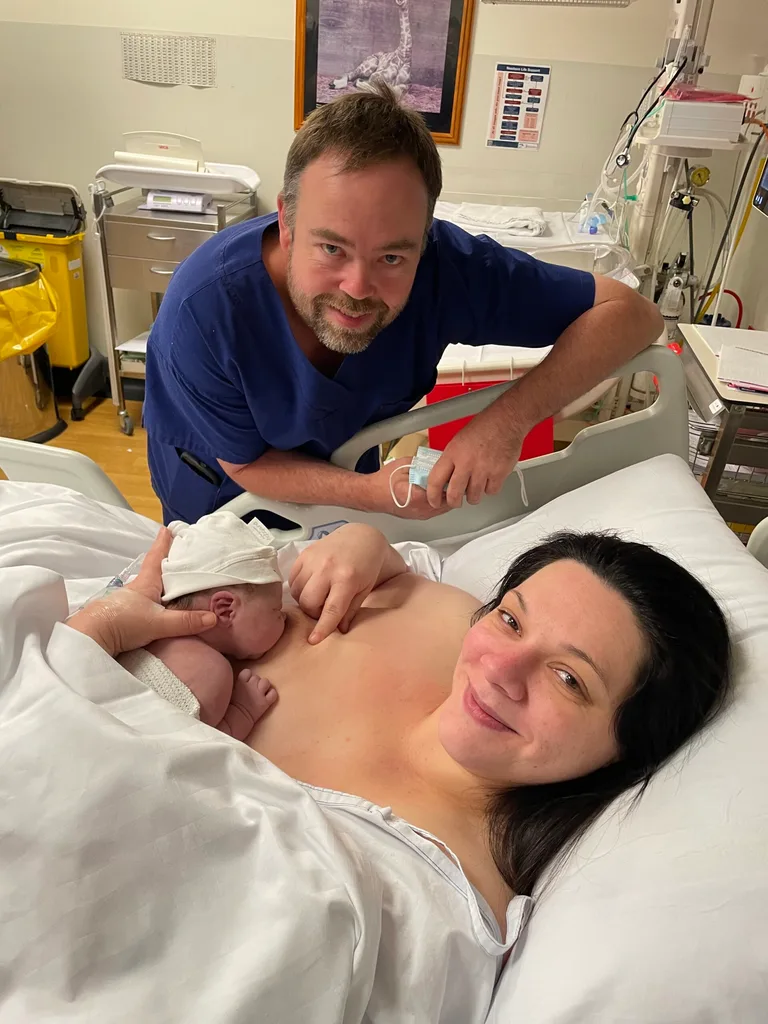 Image of mother and father with newborn in hospital
