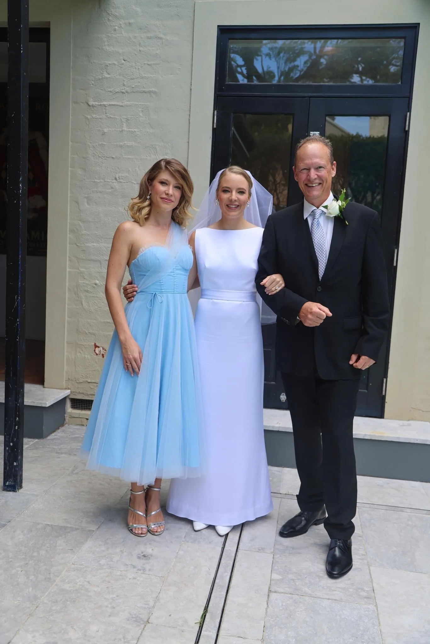 Alyssa (left) and Rhiannon (centre) with their dad (left) on Rhiannon's wedding day