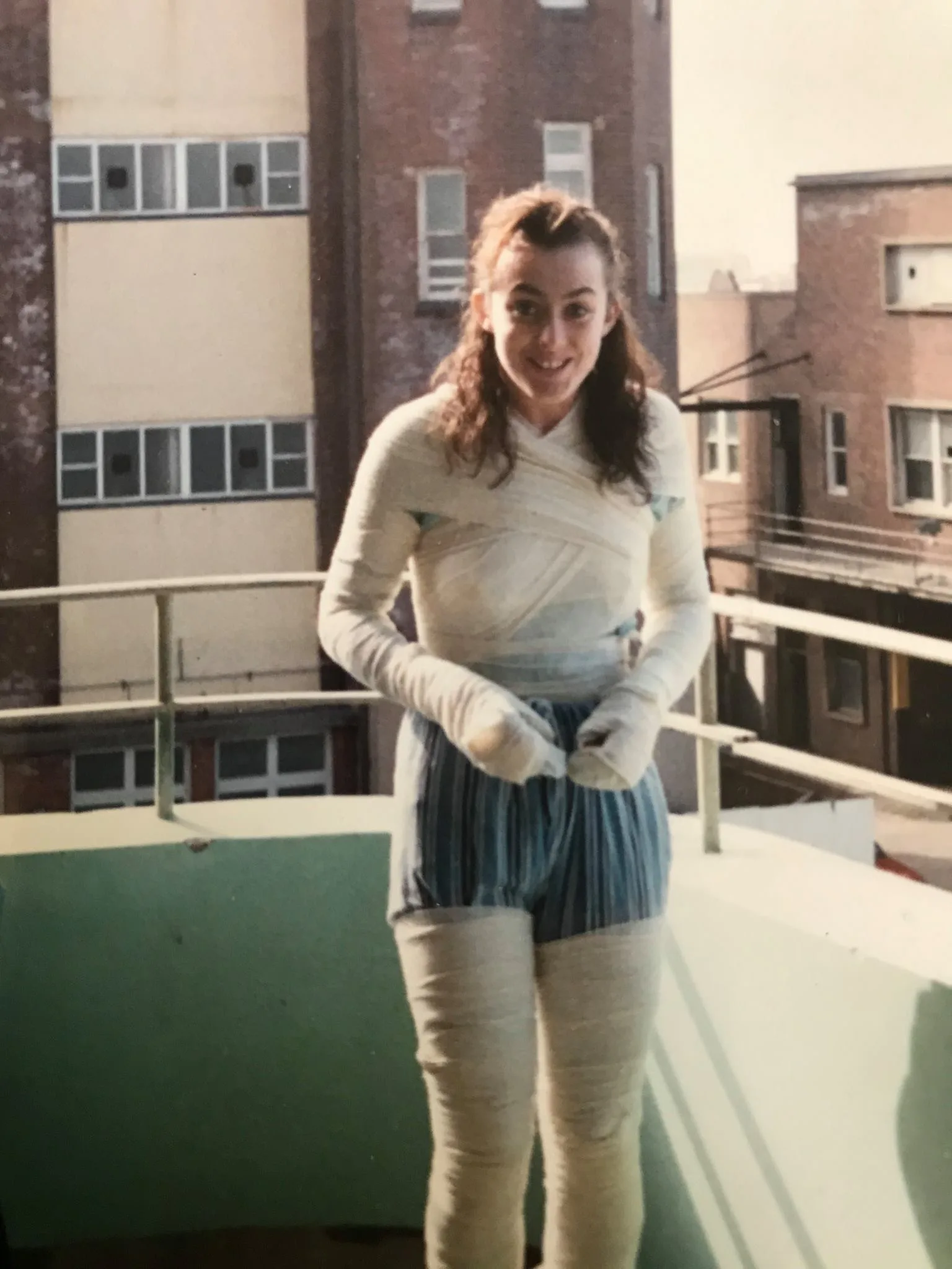 woman with arms legs and chest bound in bandages