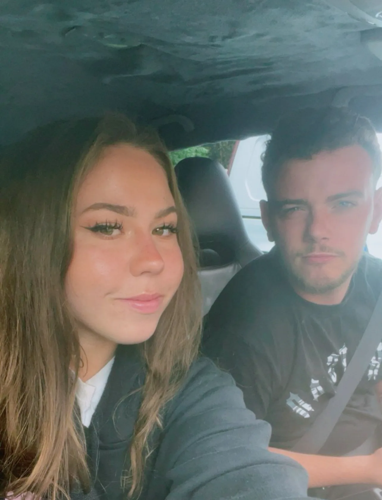 Left: Girl with long brown hair and eyelashes wearing black hoodie and looking into camera.
Right: Man wearing black shirt with short blonde hair looking into camera.