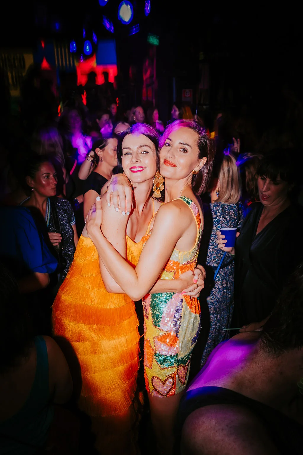Sarah and Lise hug on dancefloor