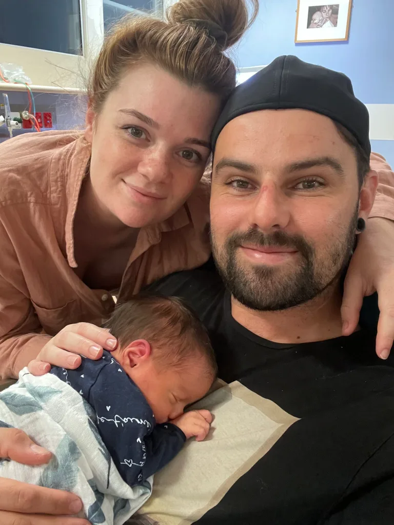 Image of parents with their newborn