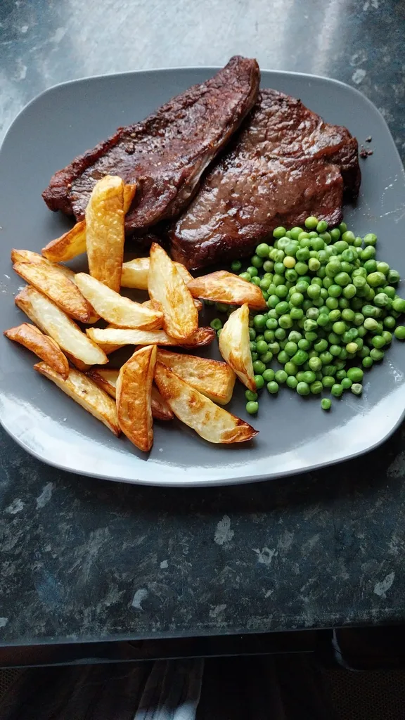 Steak, potatoes and peas