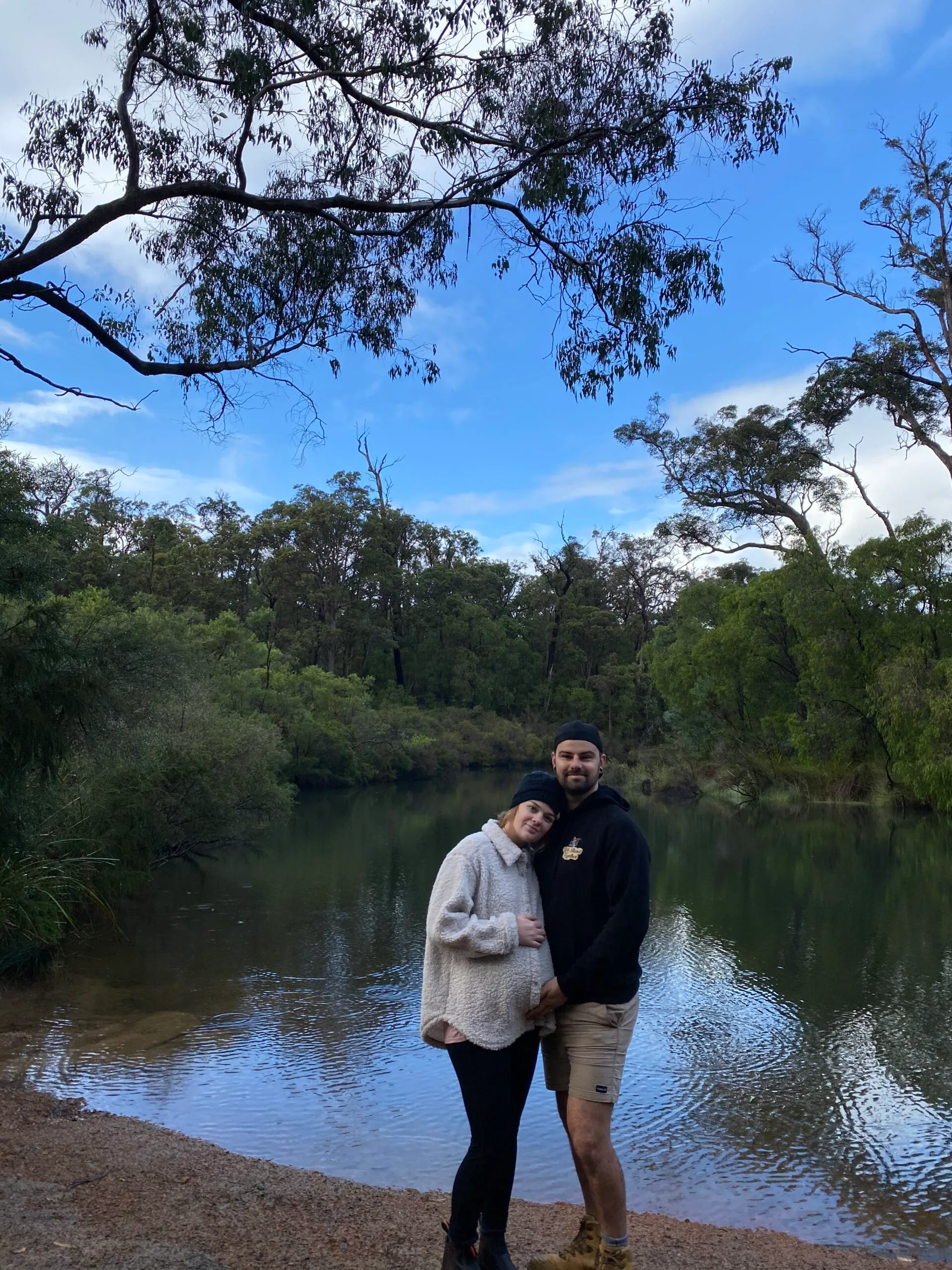 Image of husband and pregnant wife on camping trip