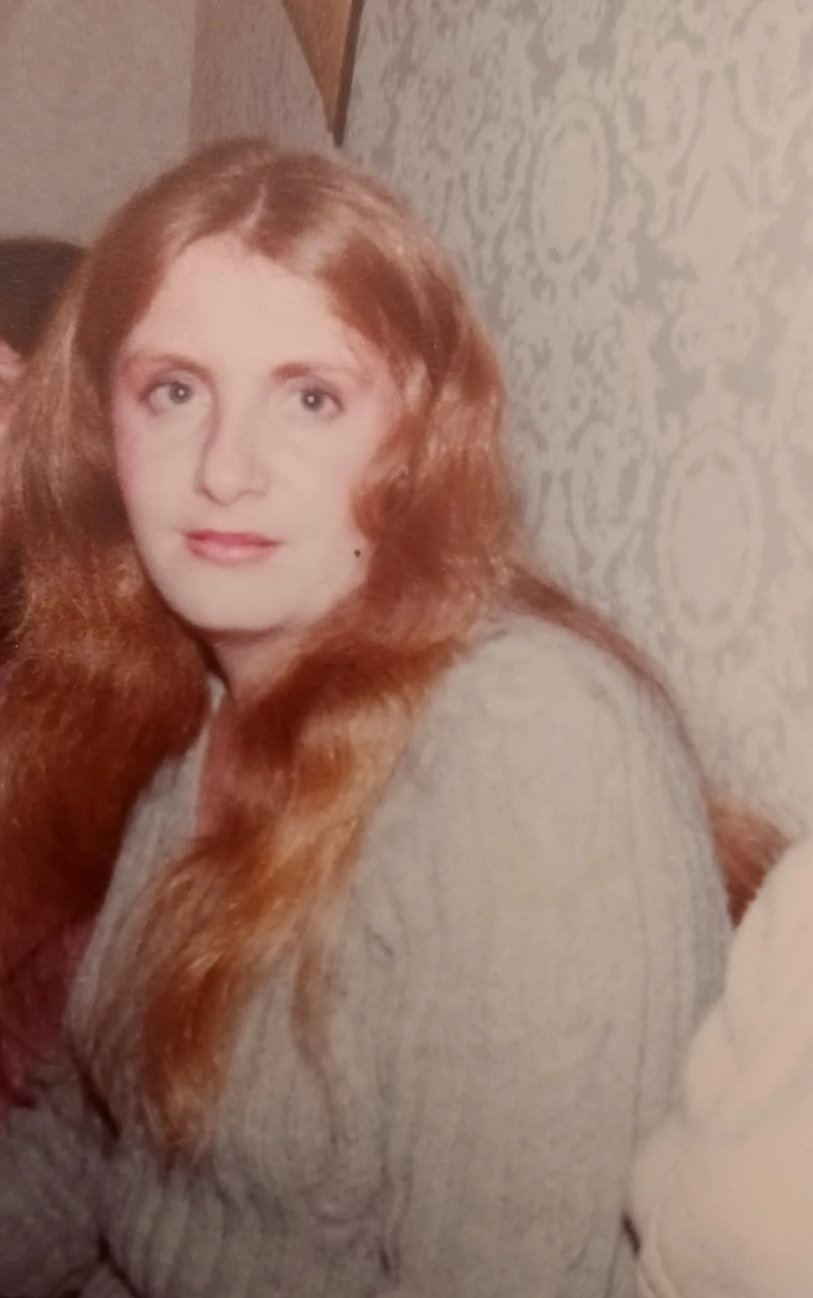 woman with long blonde hair in sweater