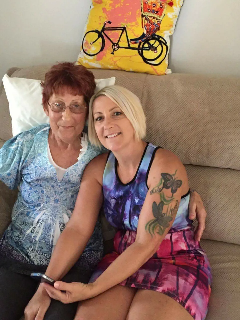 two women sitting on a couch