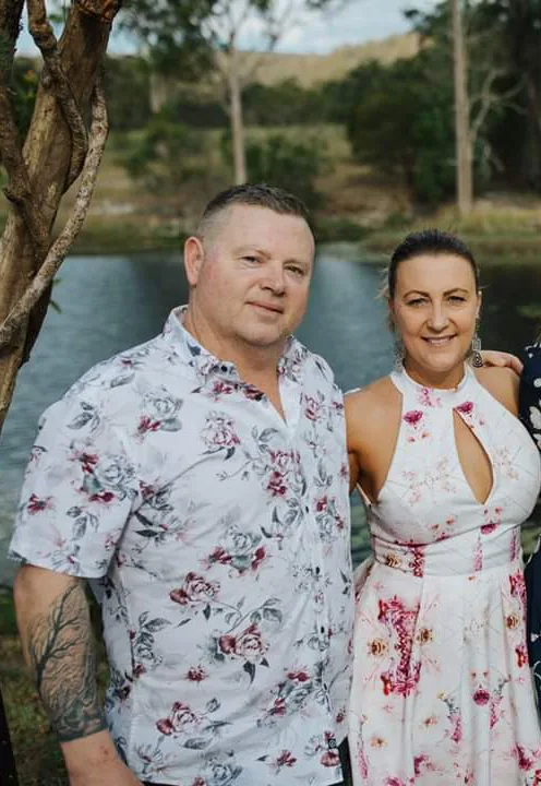 man and woman both wearing florals