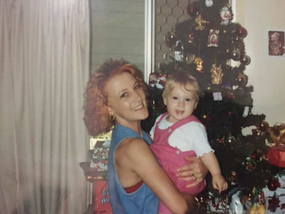 woman with red hair holding daughter