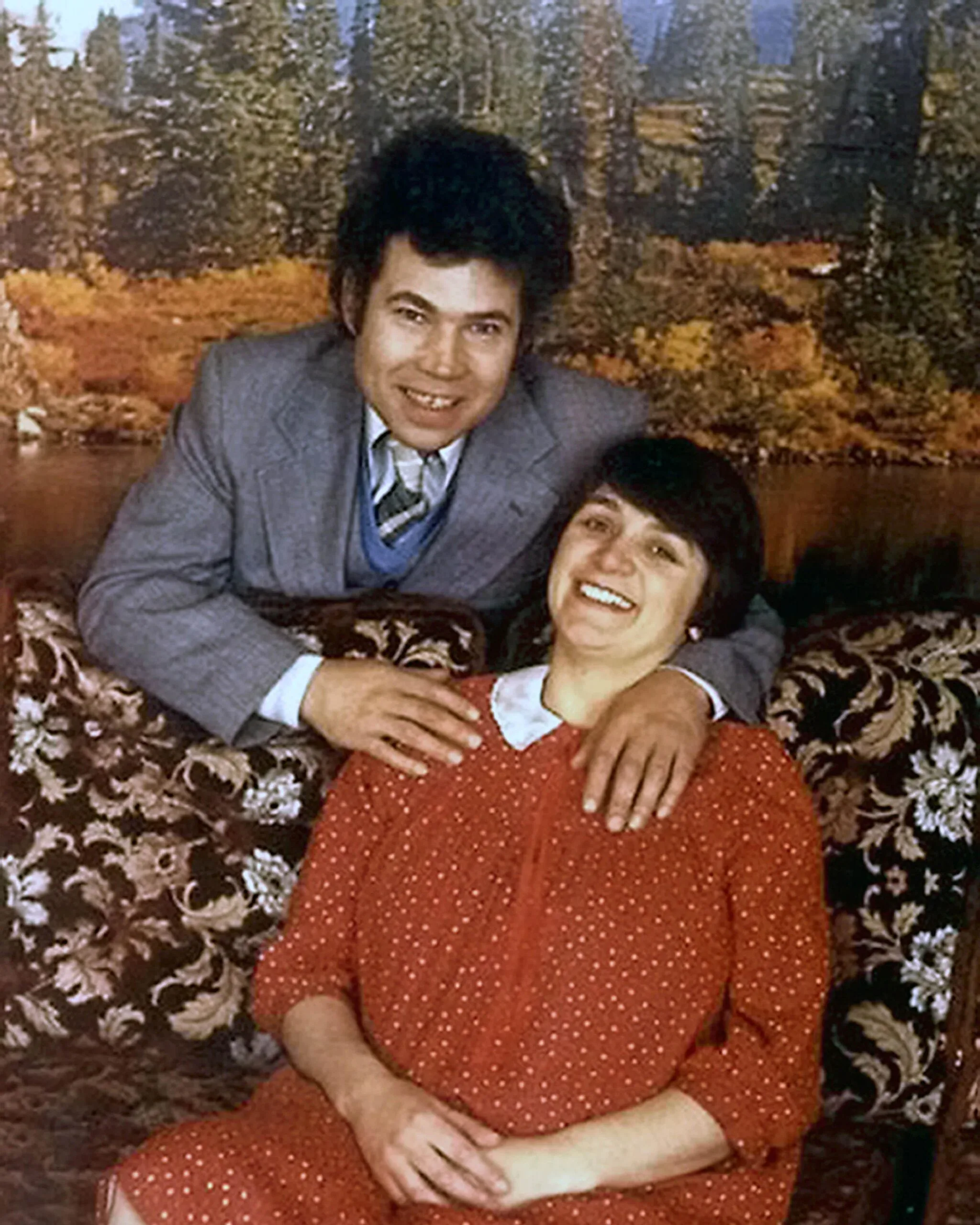 woman in spotted red and white dress and man in suit