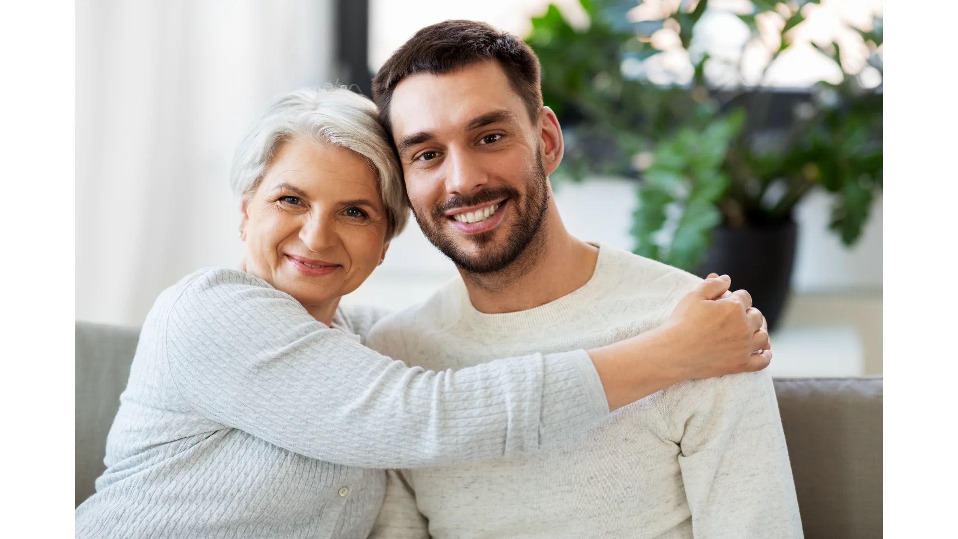 A mother embraces her adult son.