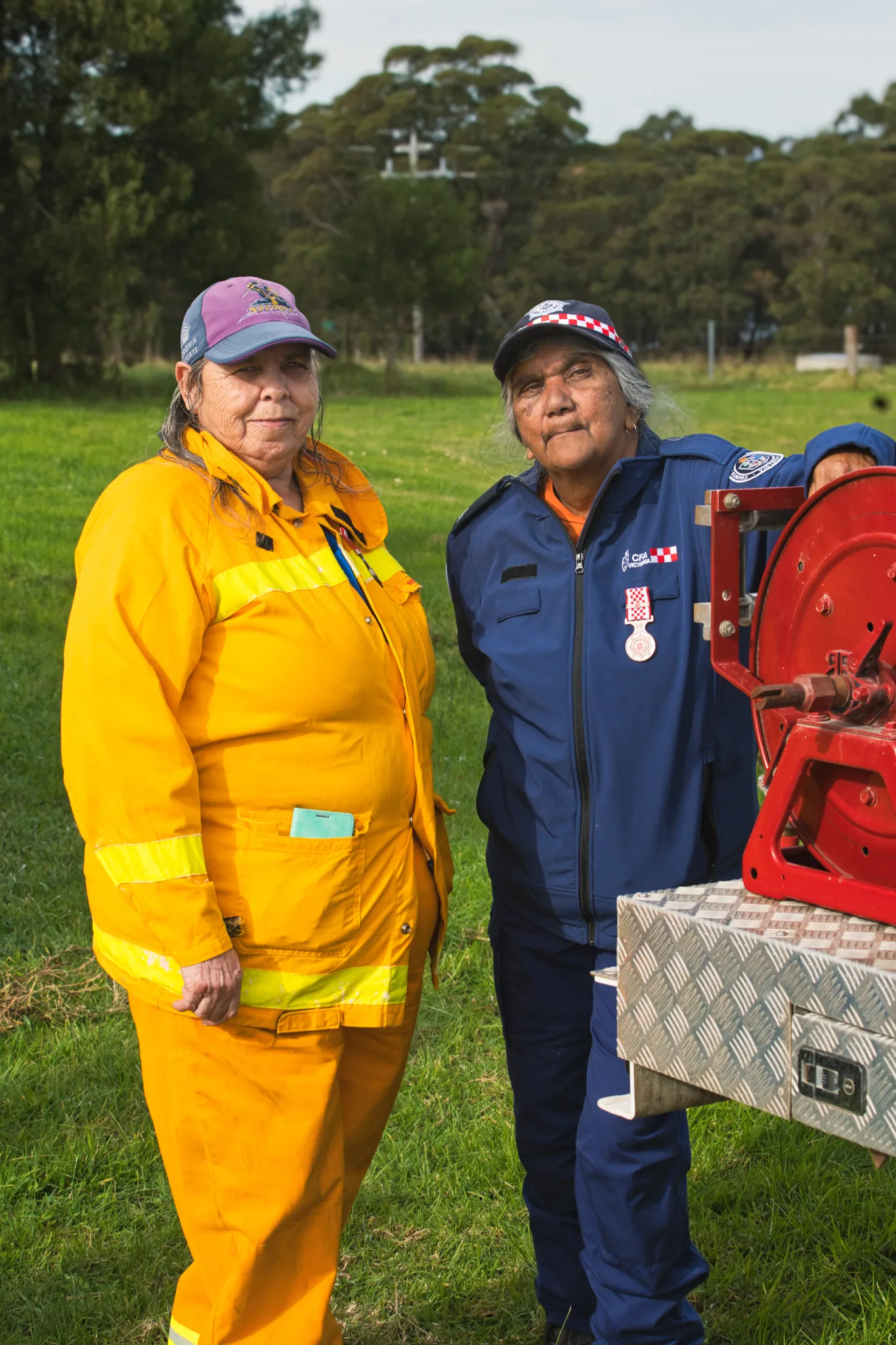 two first nations women in uniform, one yellow one blue CFA