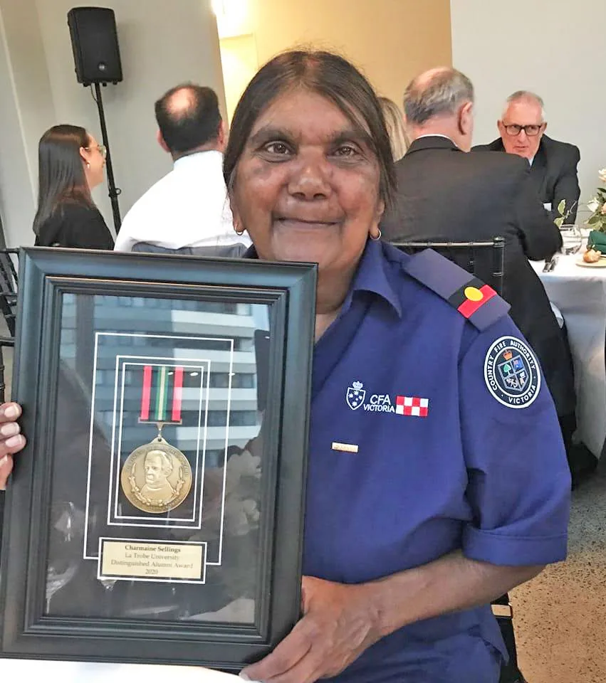 Aunty Charmaine Sellings holding her CFA award