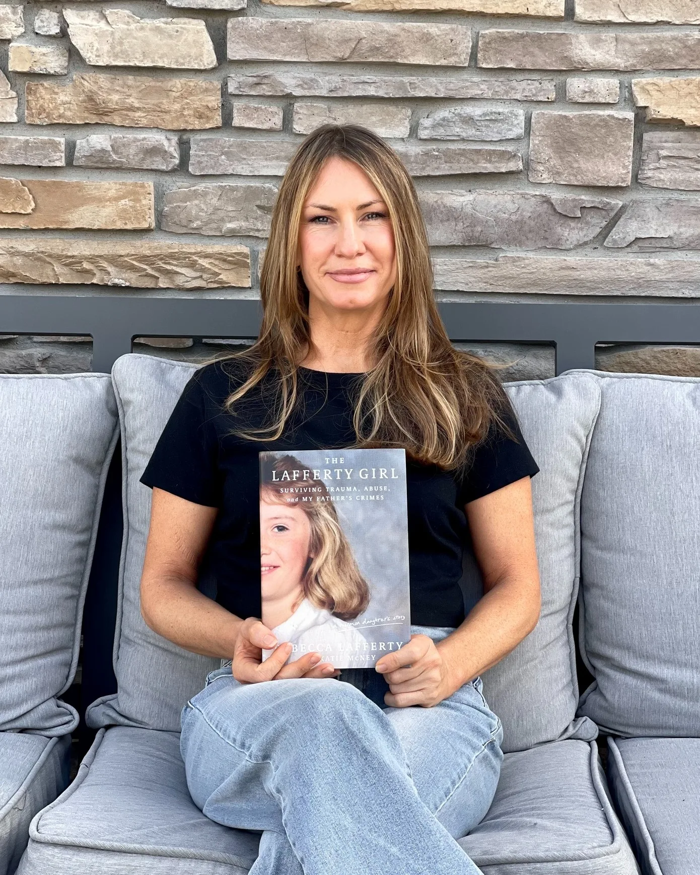 woman holding her memoir