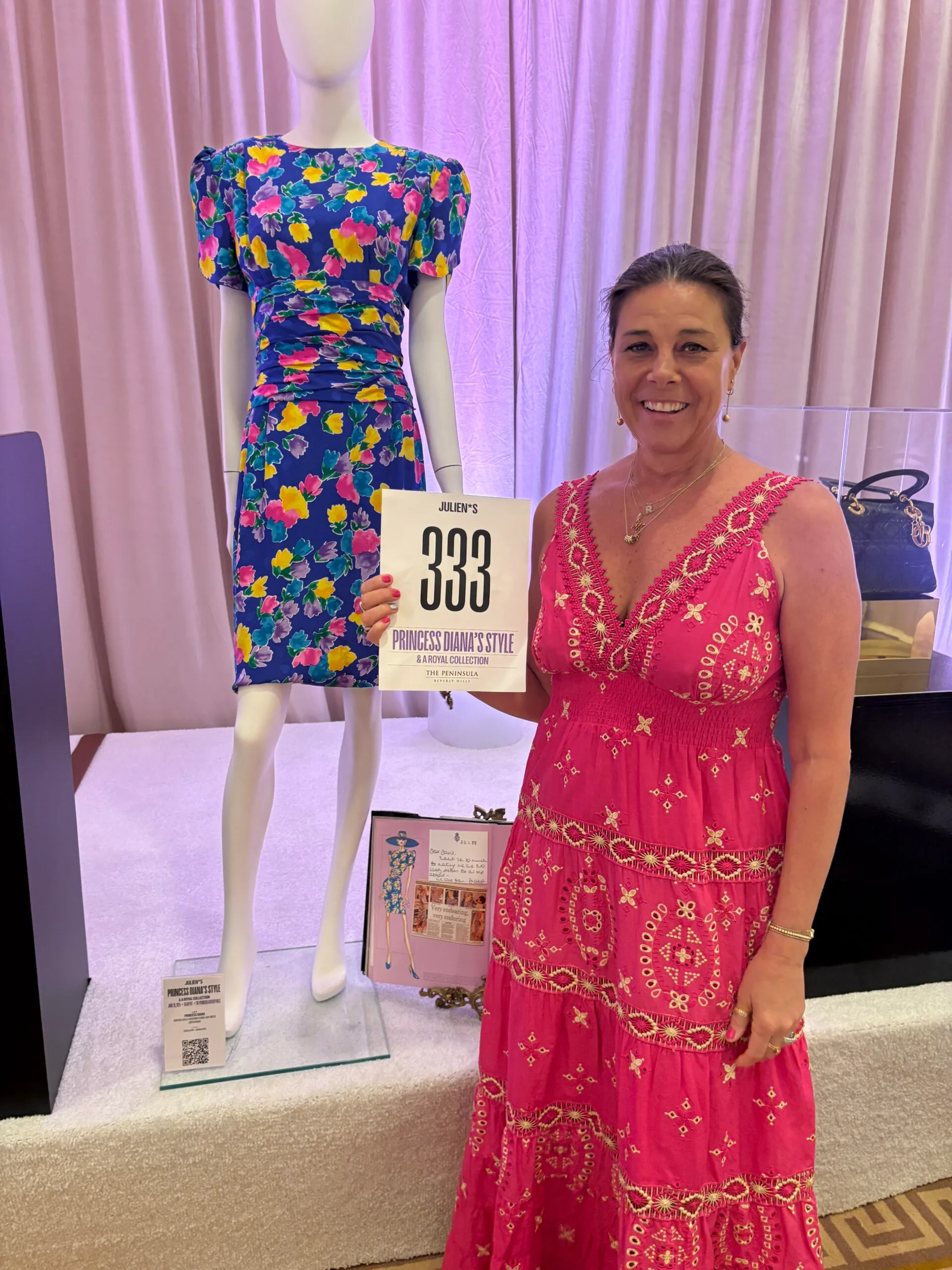 woman in pink dress at auction