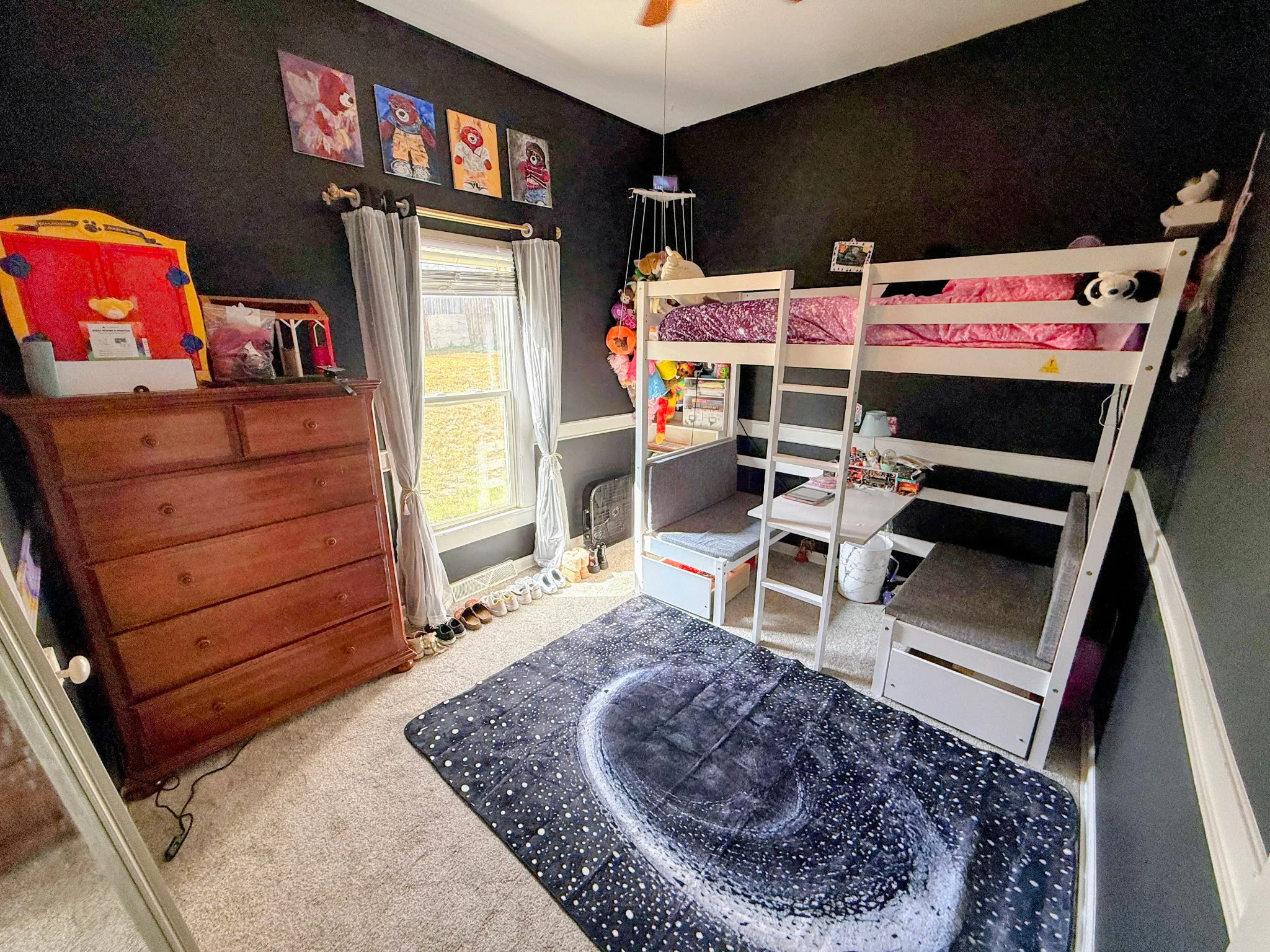 Image of a girl room with a tidy bunk bed, chest of drawers and clean carpet.