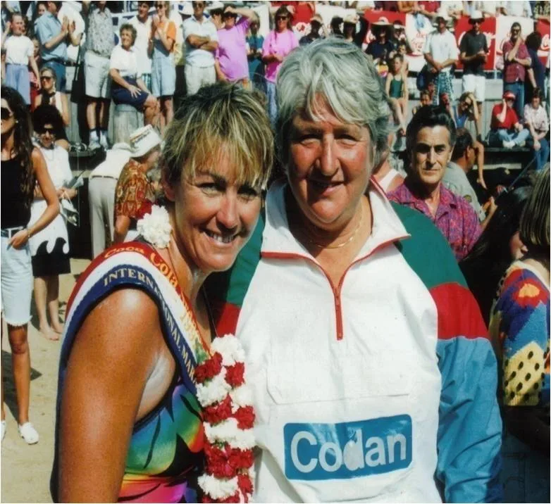 two women arm in arm in 90s