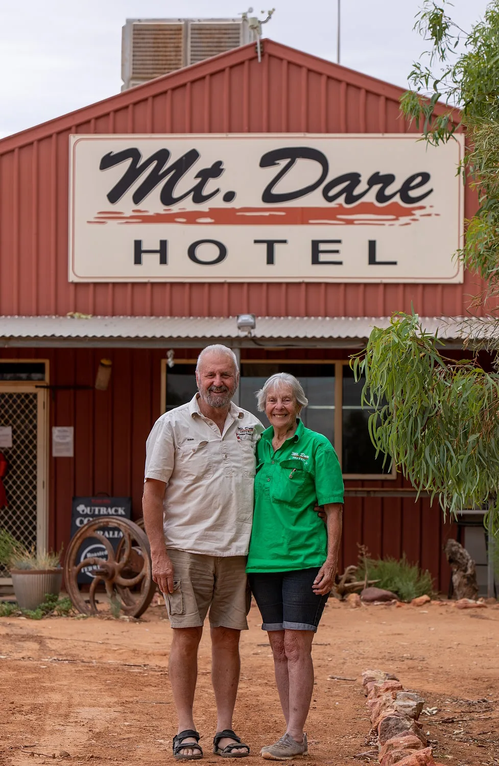 Two Australian's standing in front of an outback pub called Mt. Dare Hotel