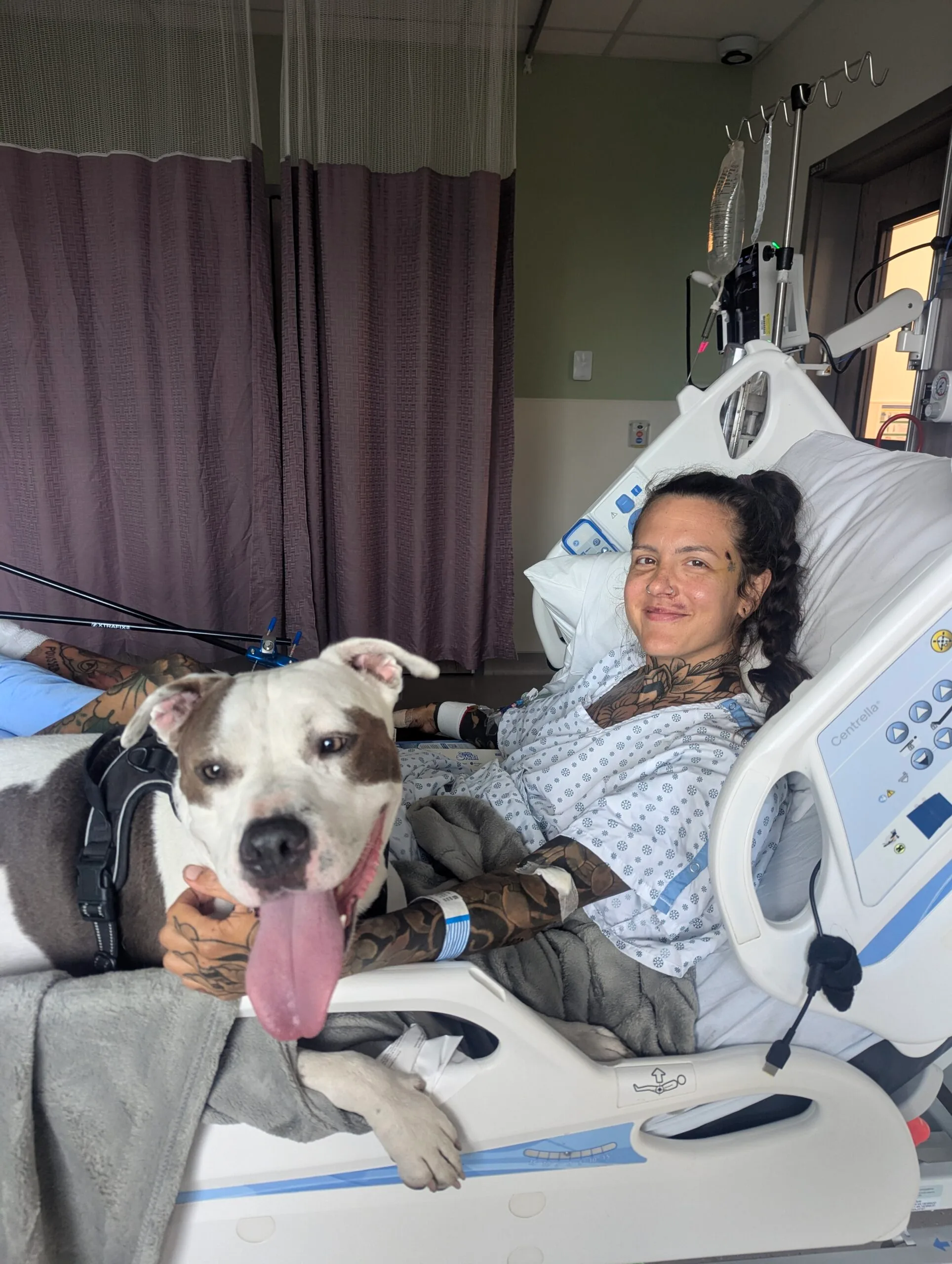 Image of woman recovering in hospital with dog