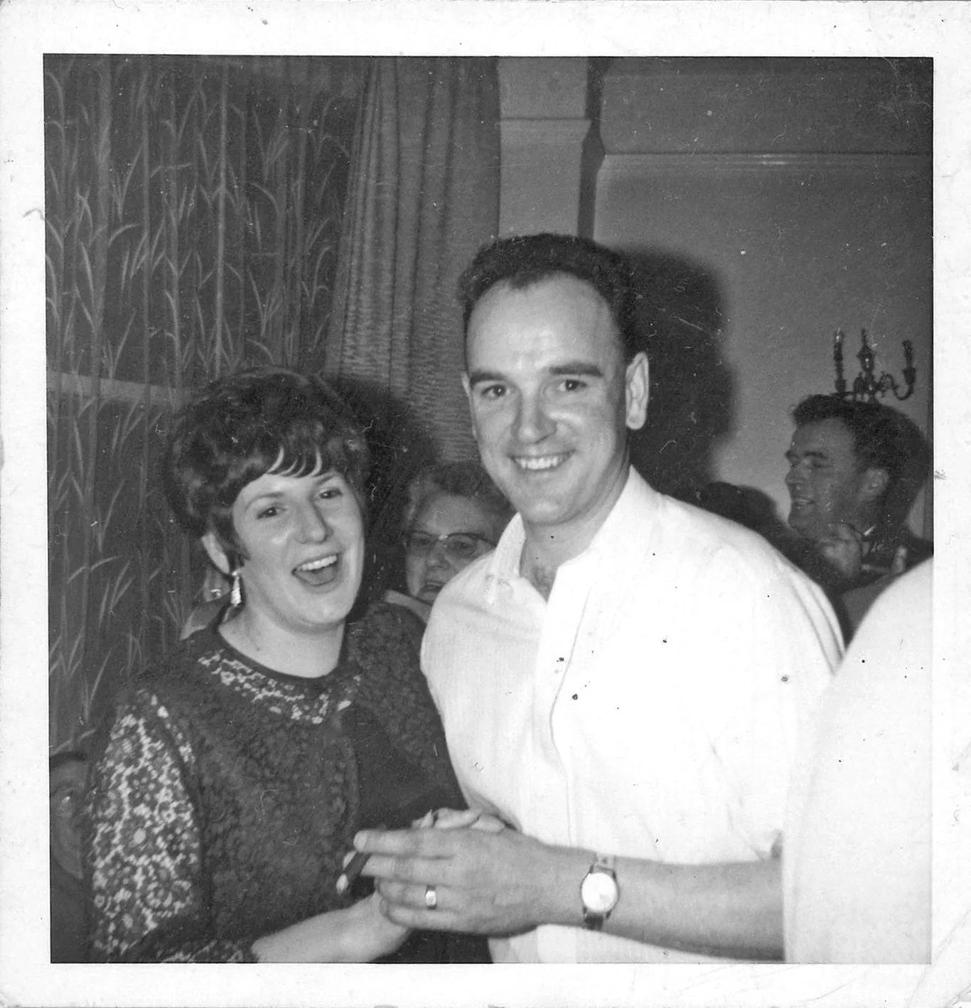 man and woman at a party black and white photo